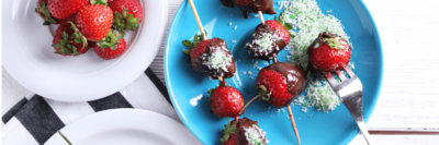 Plate with strawberries covered in lactose-free dark chocolate